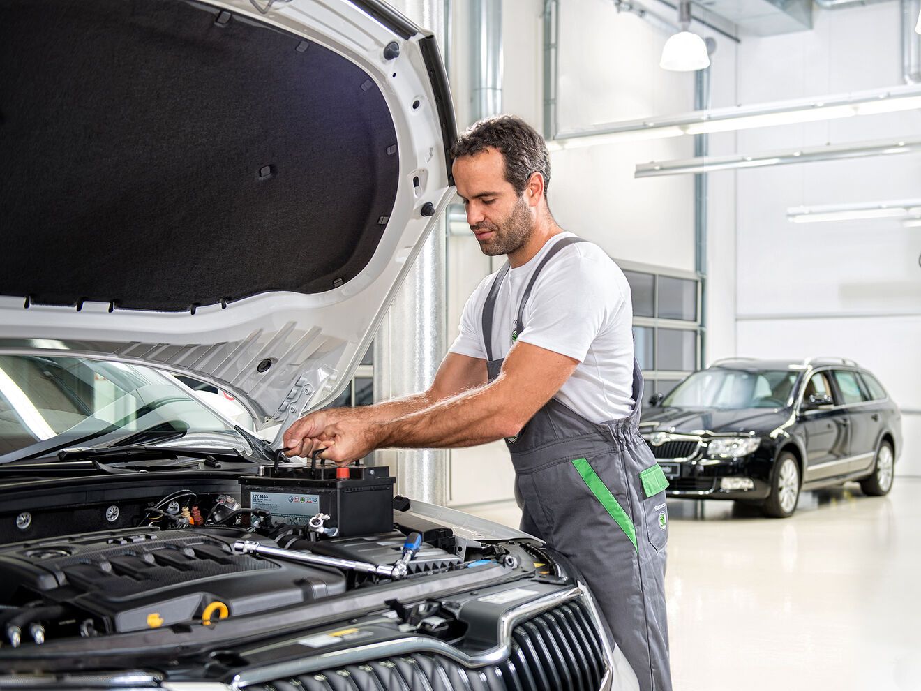 Ein Škoda Mechaniker beim Batterie Wechseln 