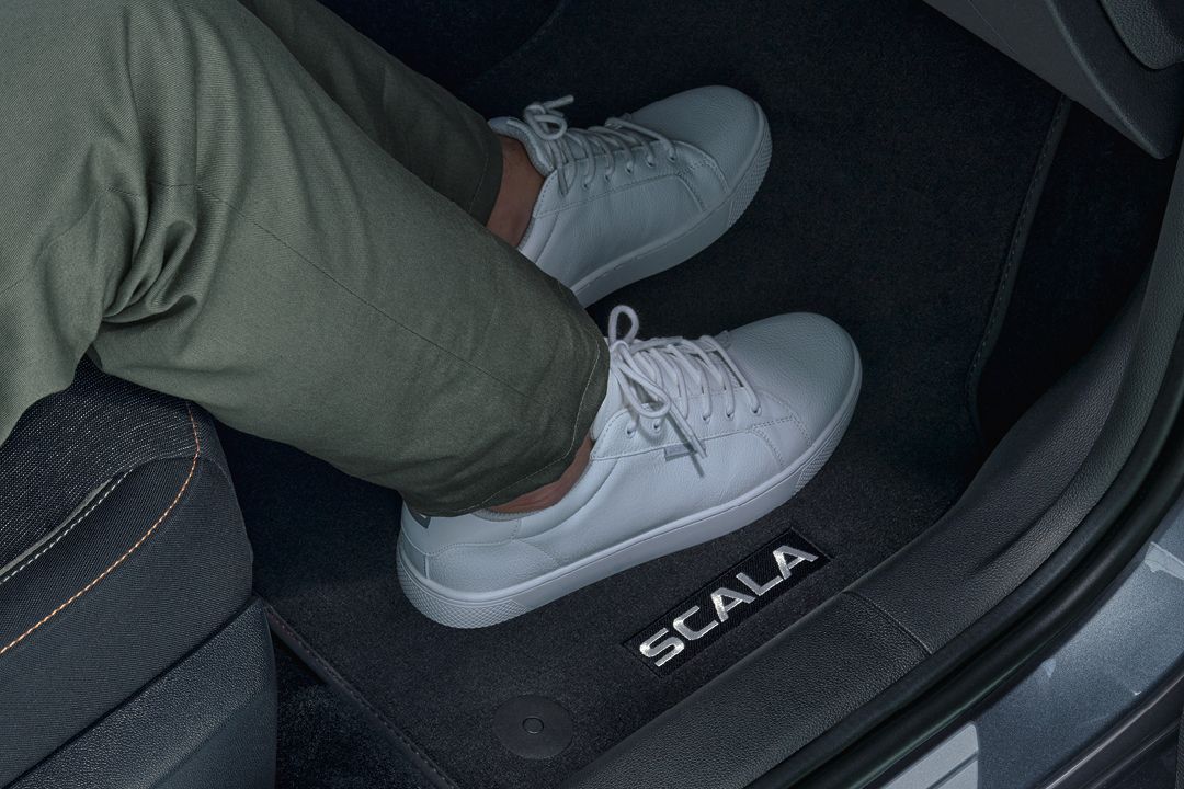 Škoda  Scala Fußmatte, zu sehen sind auch zwei Beine mit weißen Sneakers