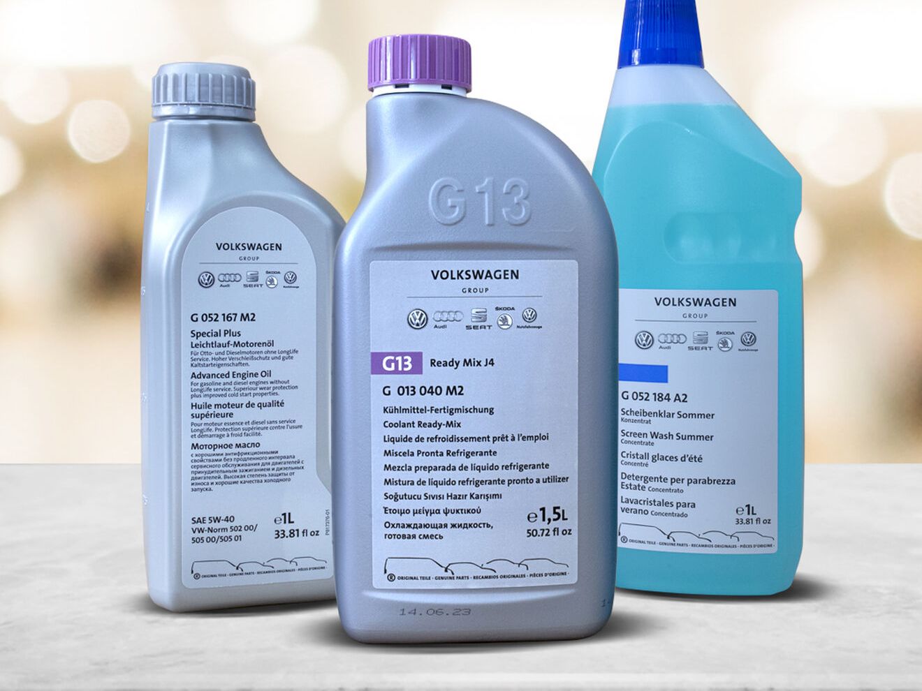 Three bottles of the Ready-to-go package solution on a grey top with warm colored bokeh background
